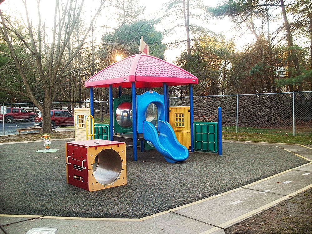 Playground with climbing structure, slide, and a square tunnel