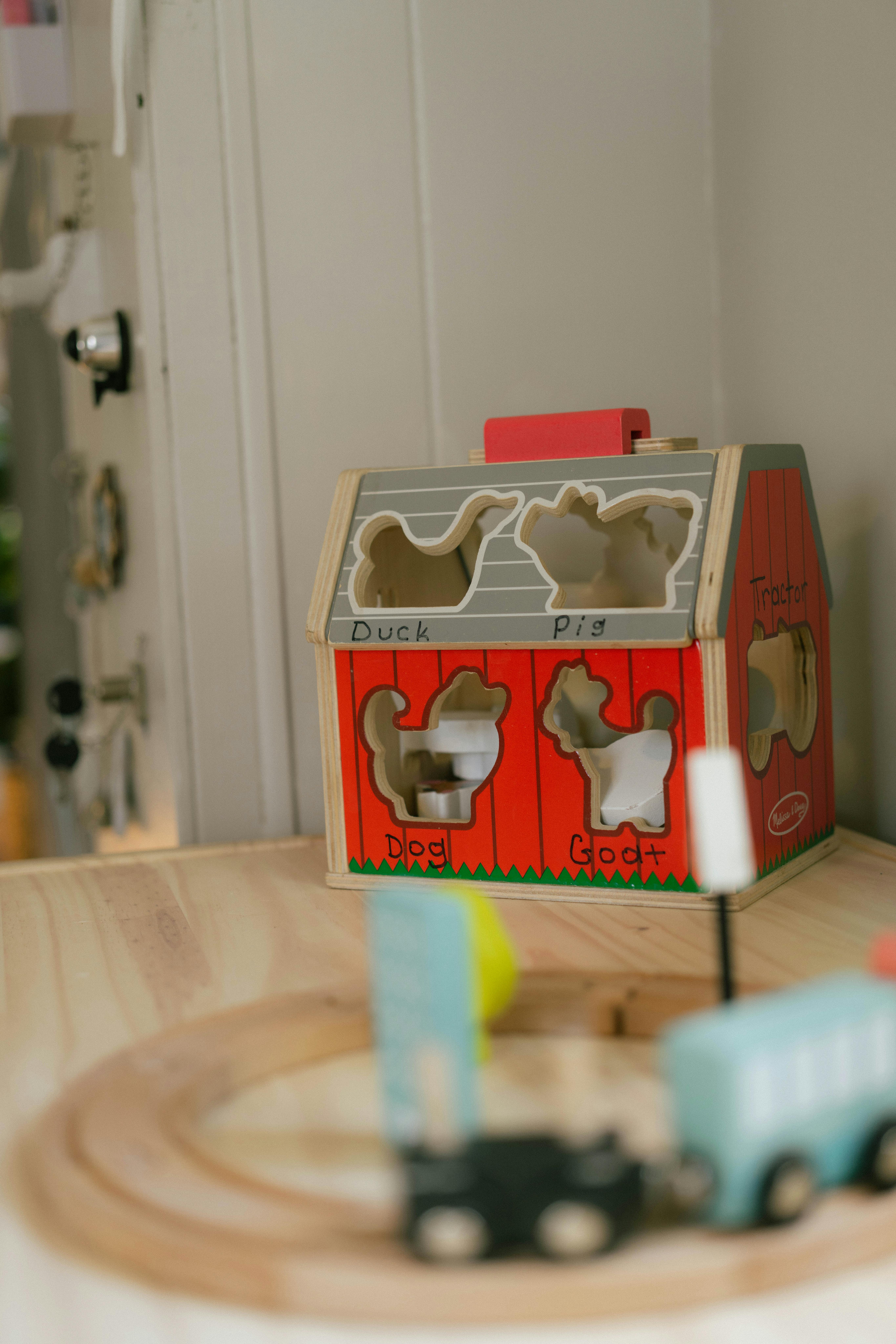 Wooden barn shaped shape sorter toy