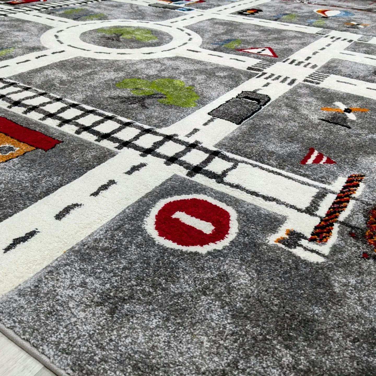 Playmat with roads, railroad tracks, and a stop sign