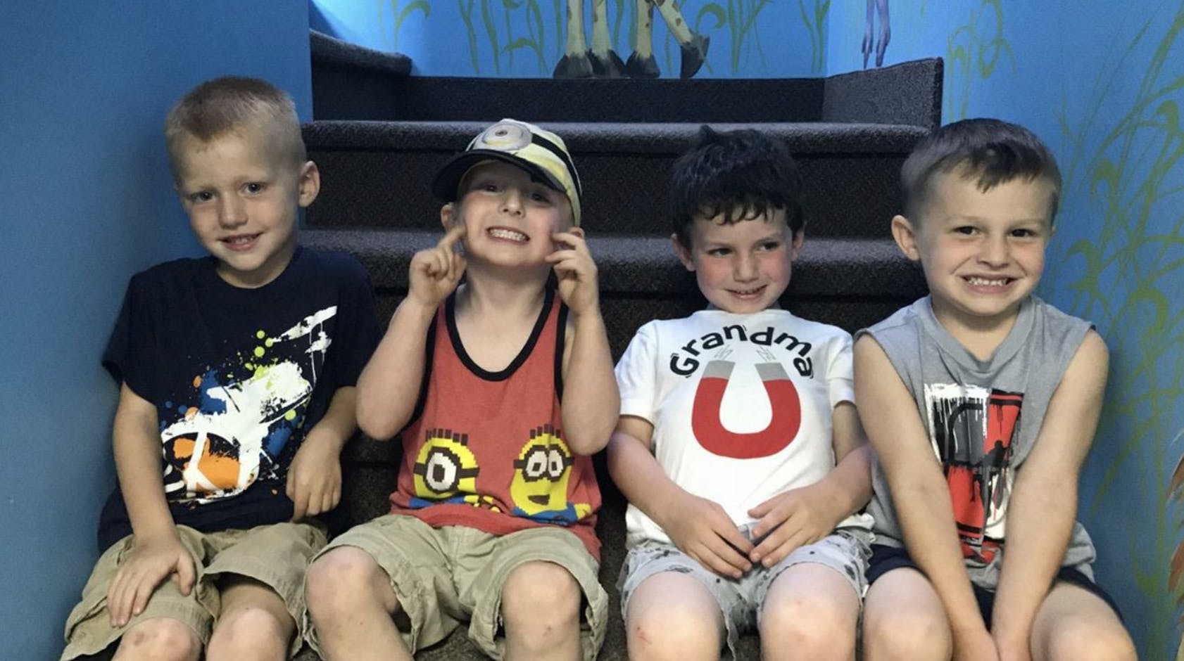 Four children sitting on steps