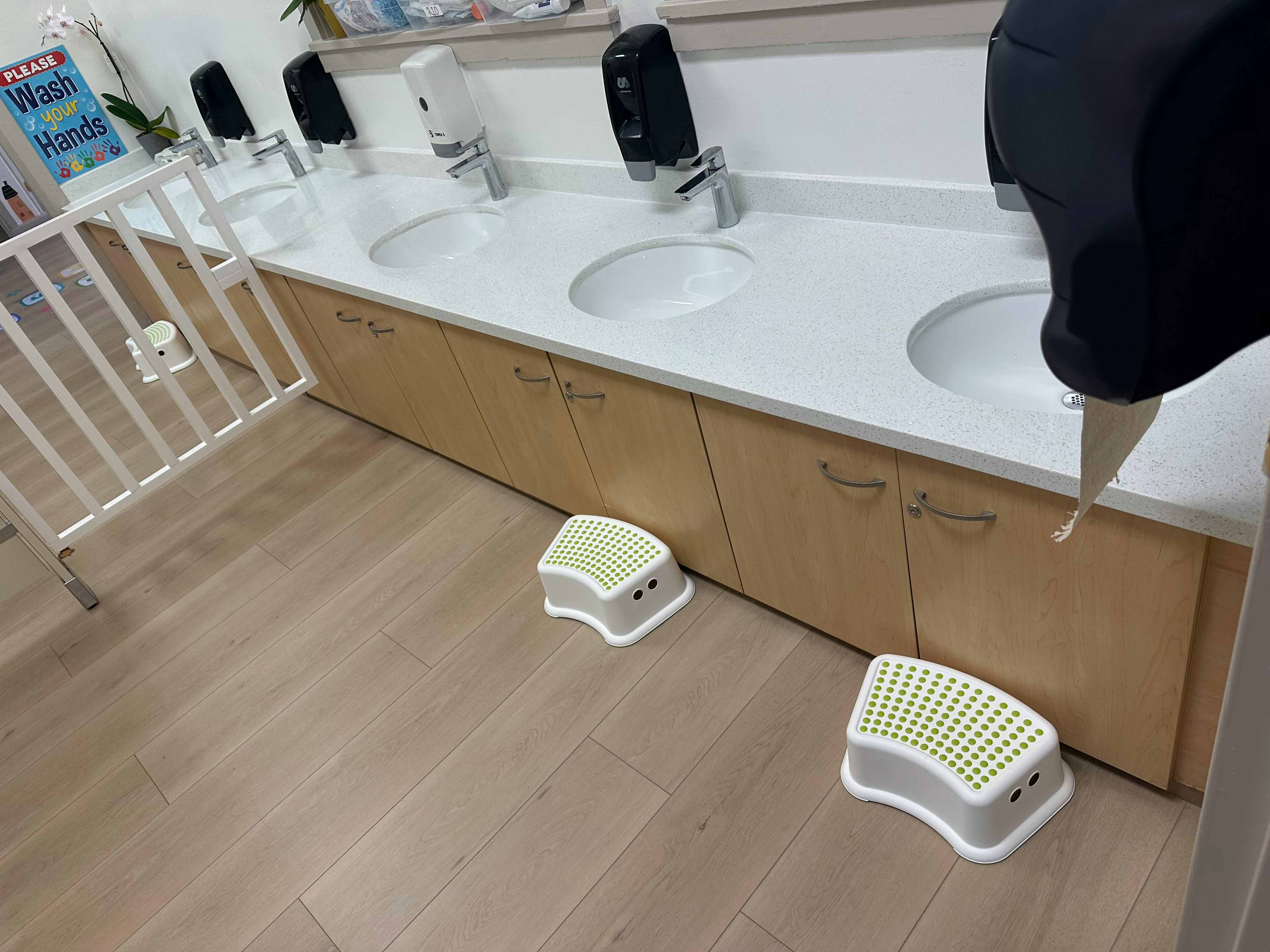 Sinks with step stools in a bathroom