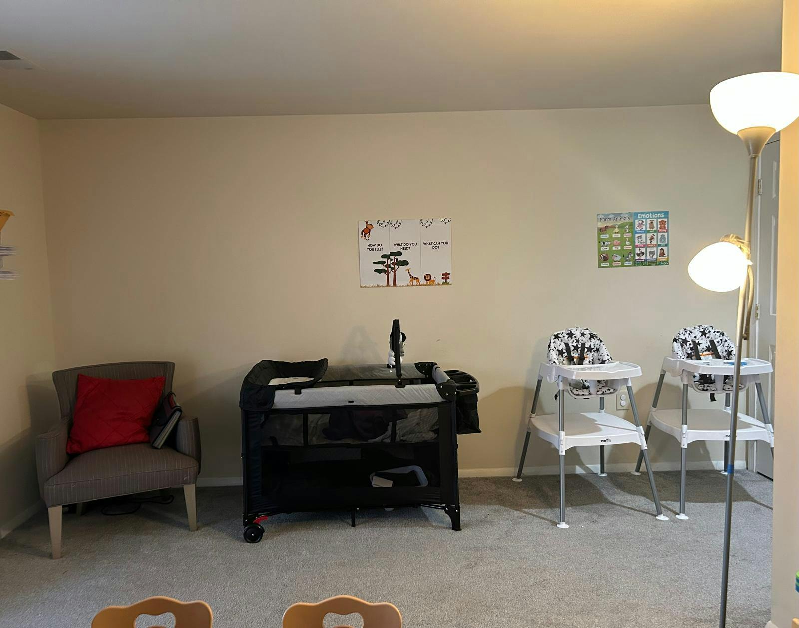 Playard and two high chairs in a room