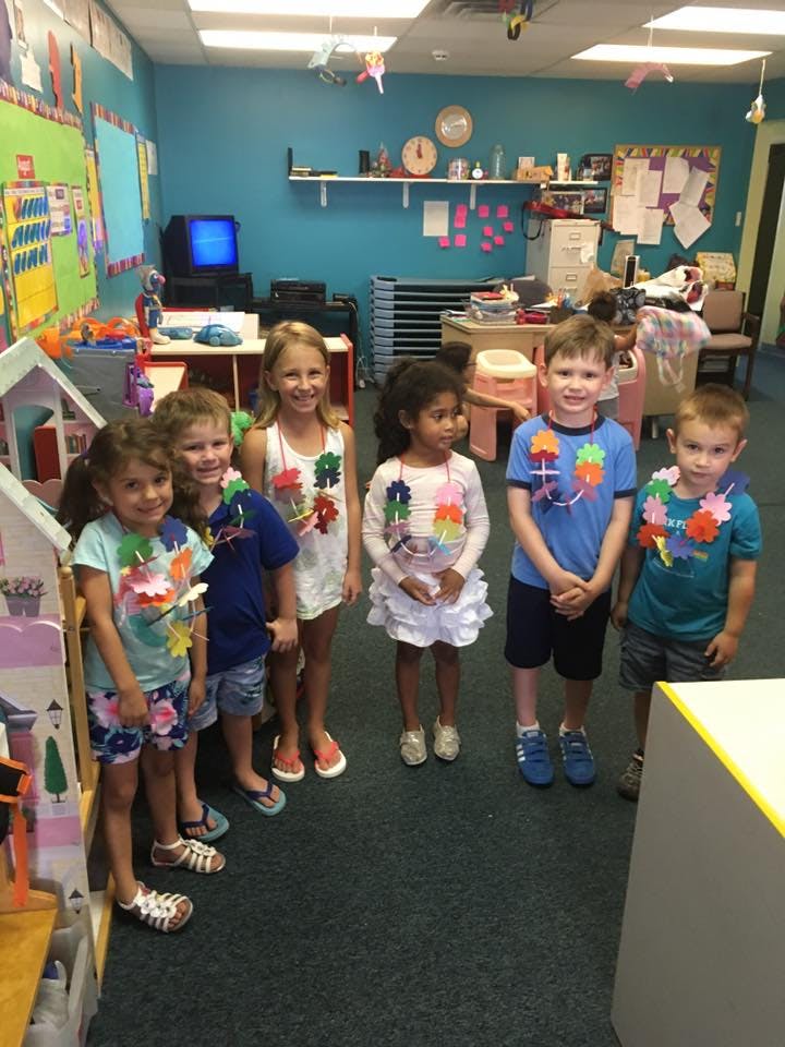 Group of children standing in a classroom