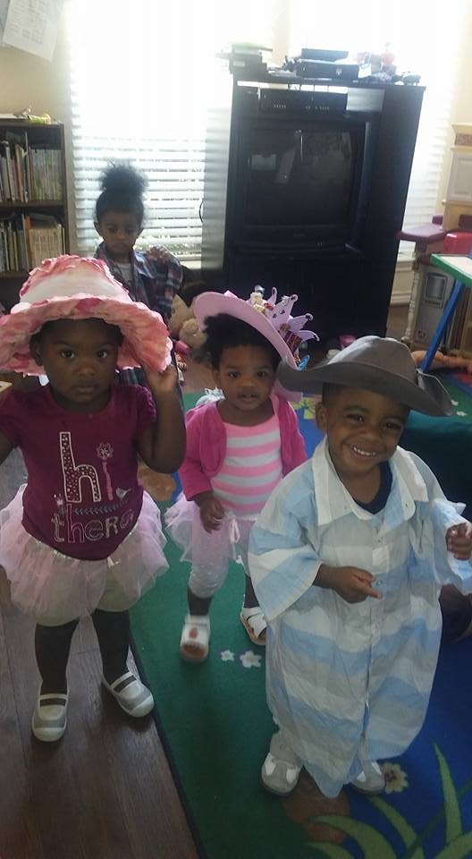 Three children in costumes and hats