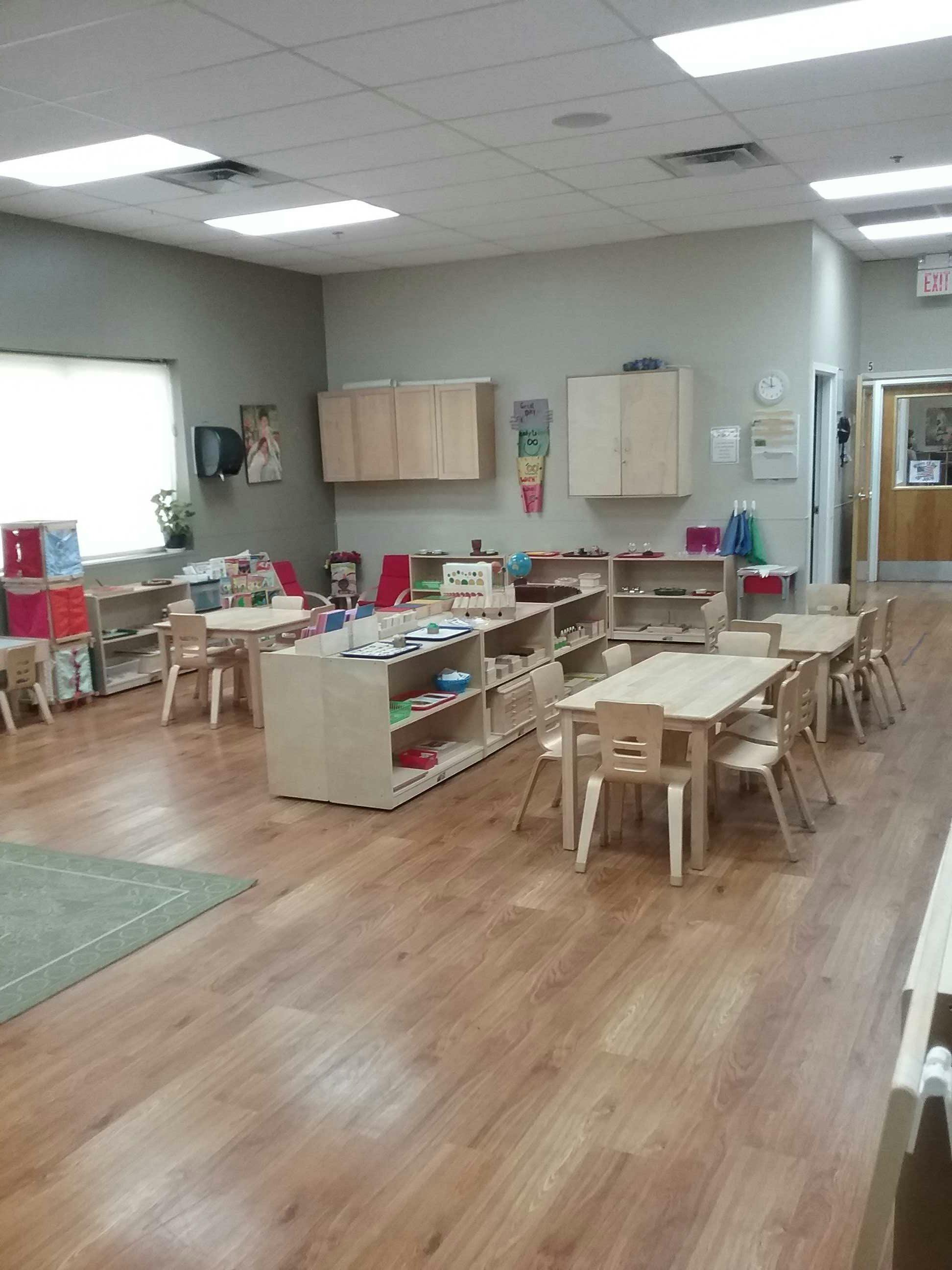 Empty classroom with small tables and chairs