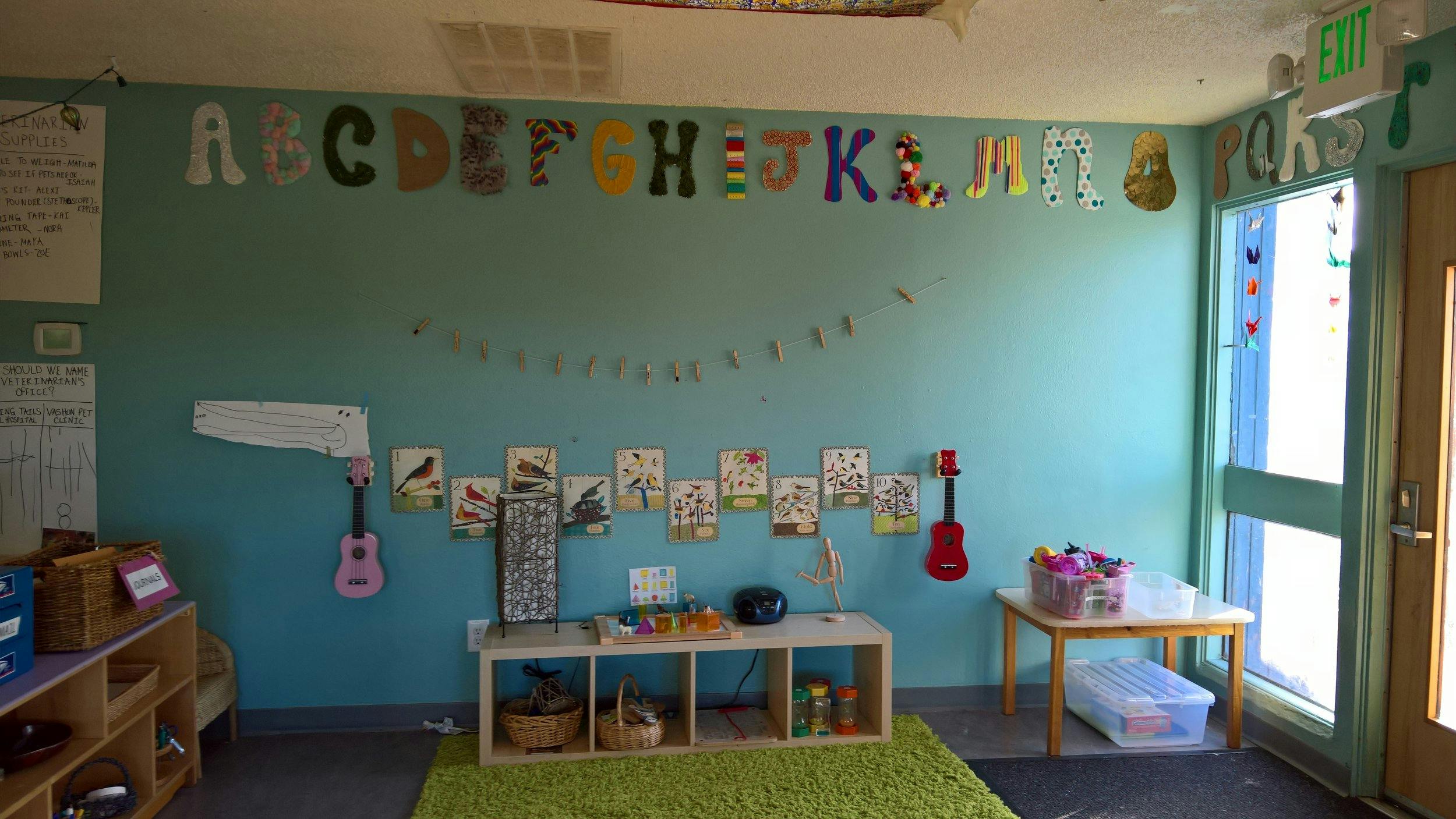 Classroom with alphabet letters on the wall and small tables