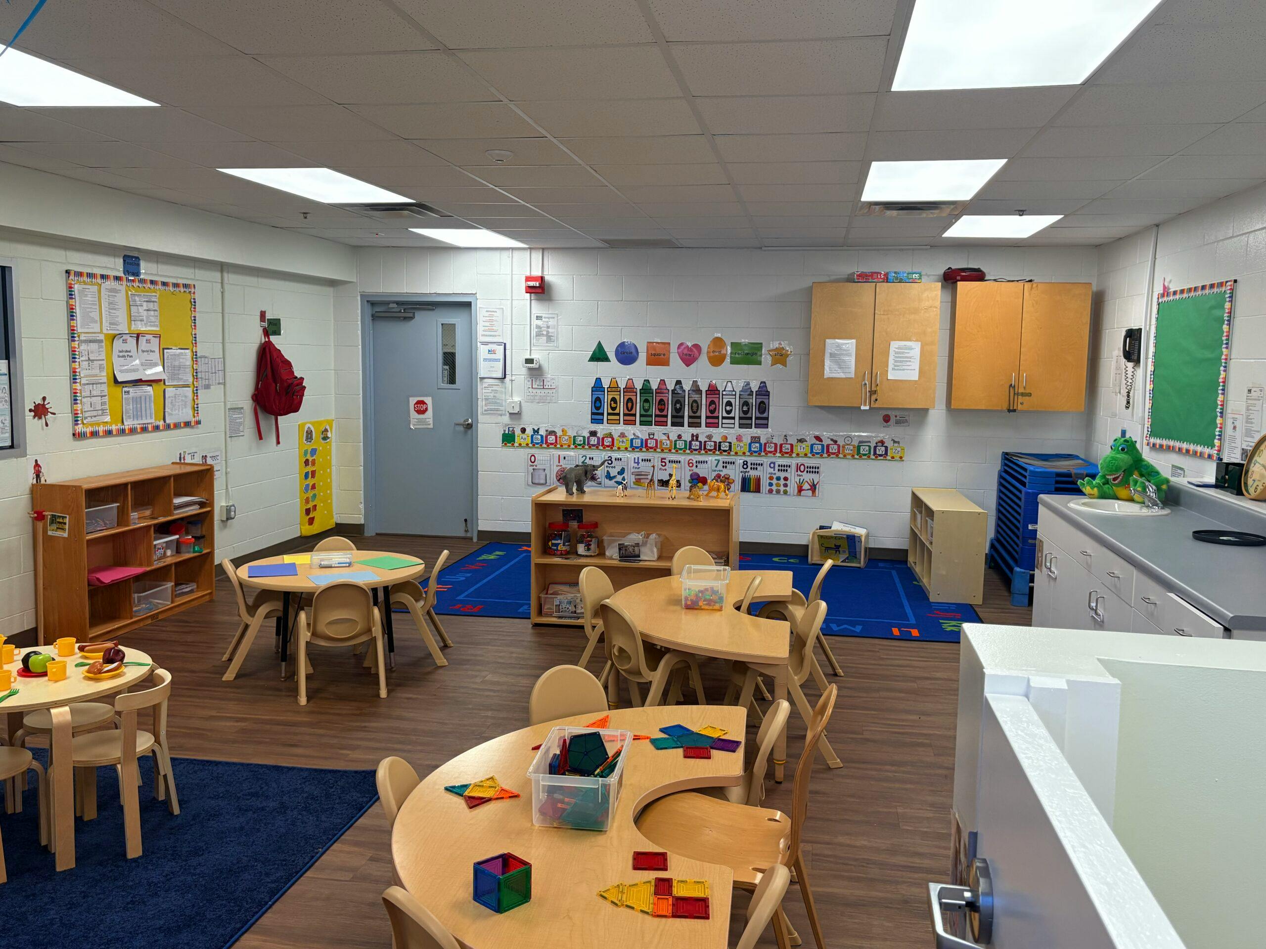Empty classroom with small tables and chairs