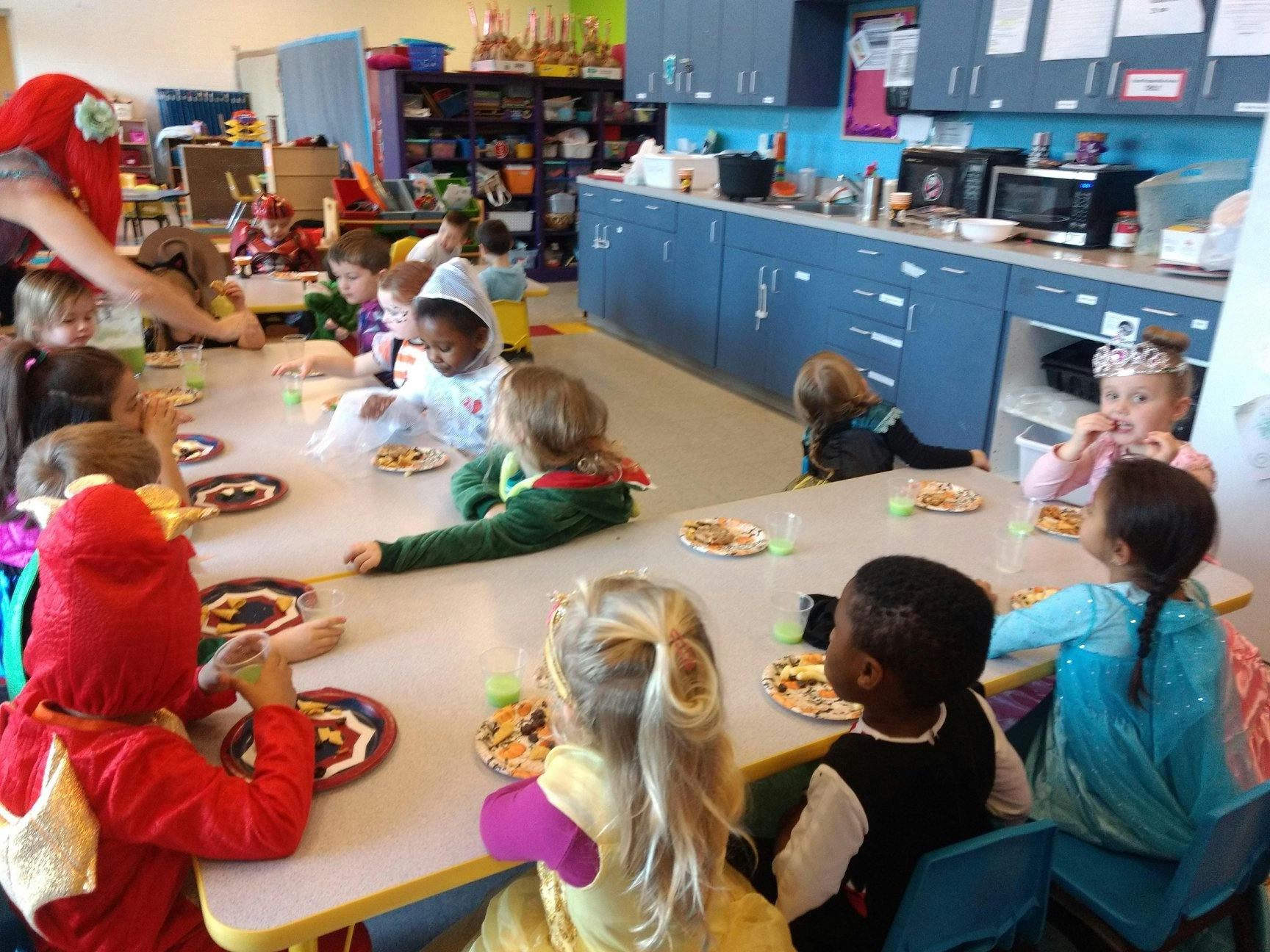 Children sitting at tables in a classroom