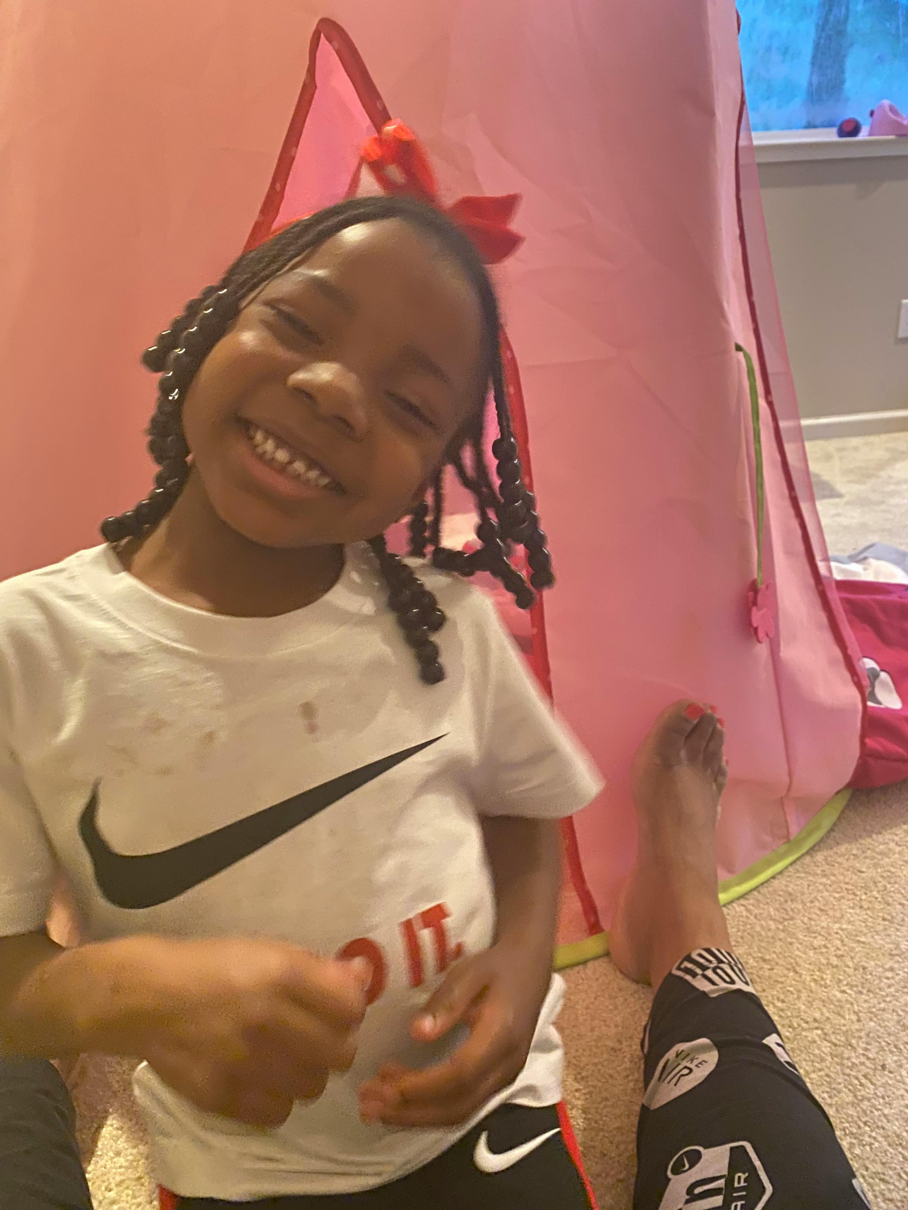 Child with braided hair smiling