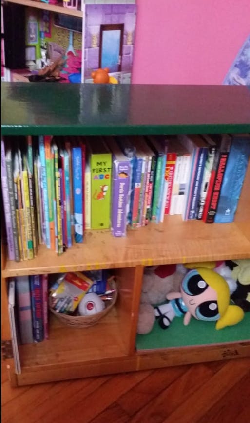 Books and toys on a wooden shelf