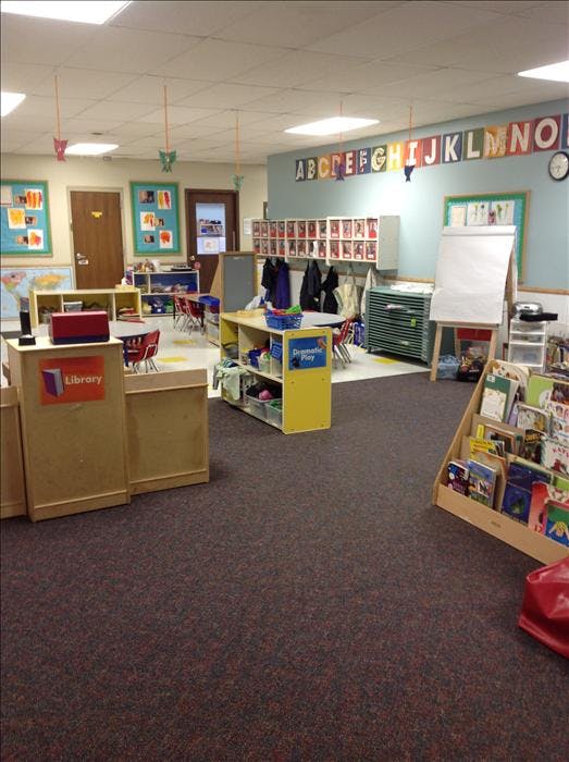 Empty colorful preschool classroom with alphabet letters on the wall