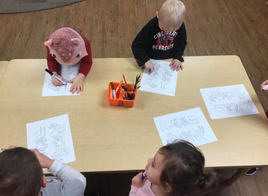 Children drawing at a table