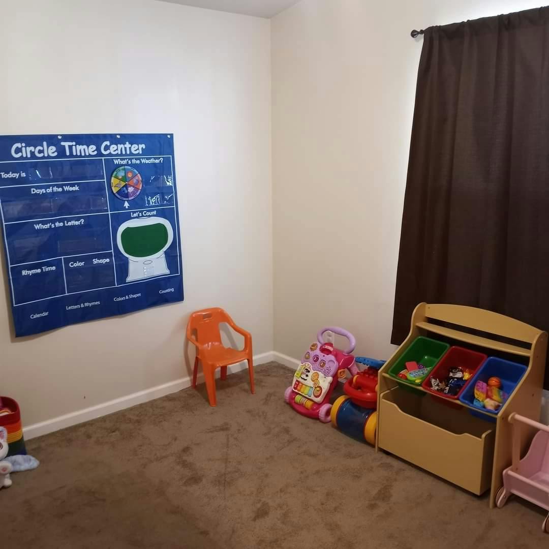 Playroom with a "Circle Time Center" chart, small orange chair, and toy storage