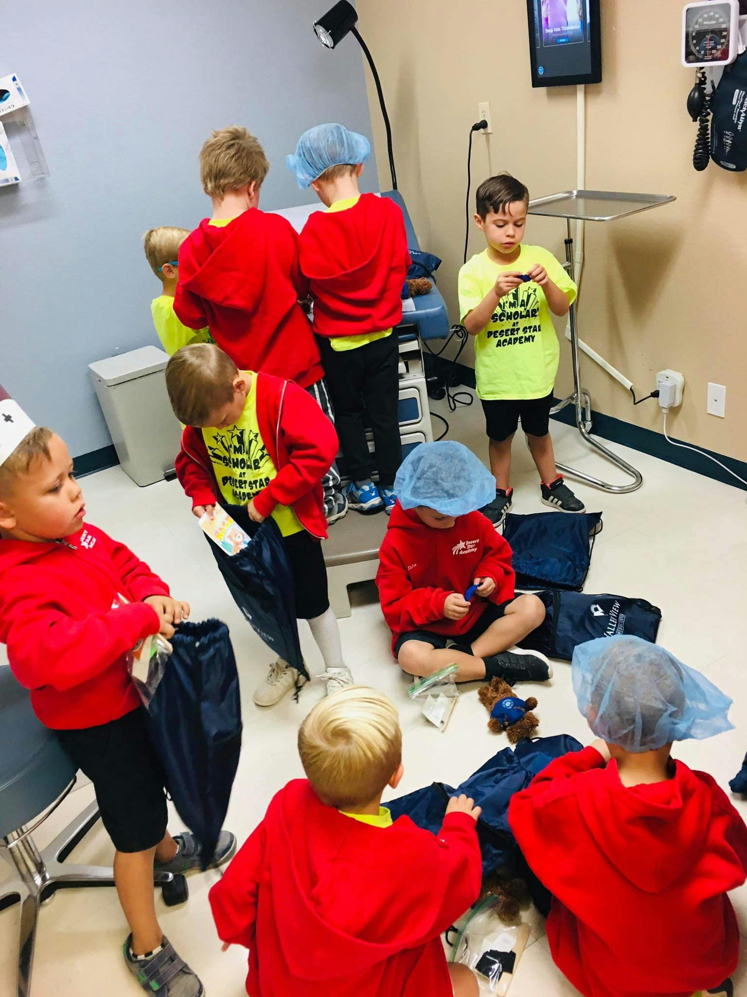 Children in red shirts and blue hairnets in a room