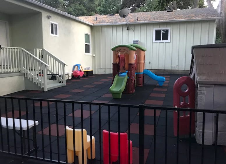 Outdoor play area with a small slide and play structure