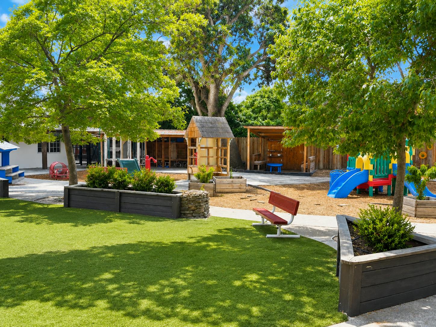 Outdoor playground with play structures and green space