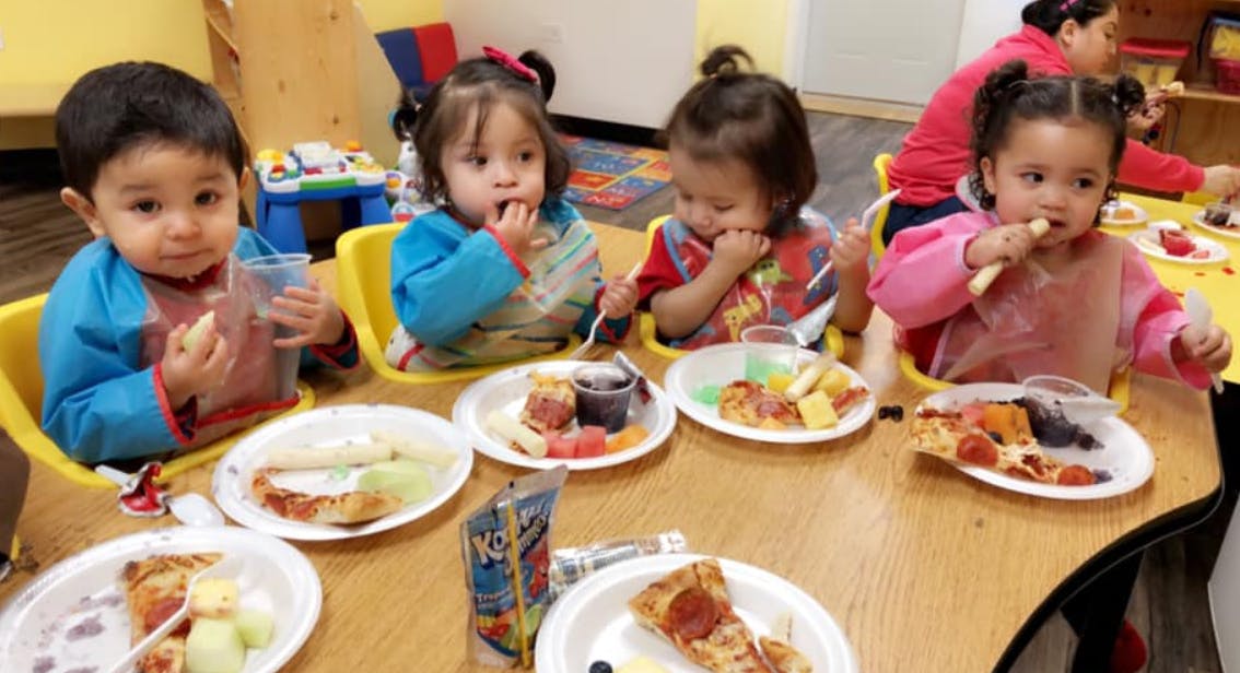 Four children eating at a table