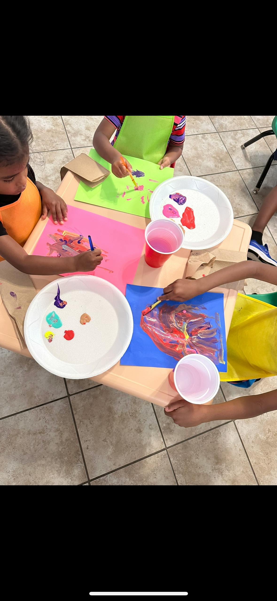 Children painting at a table