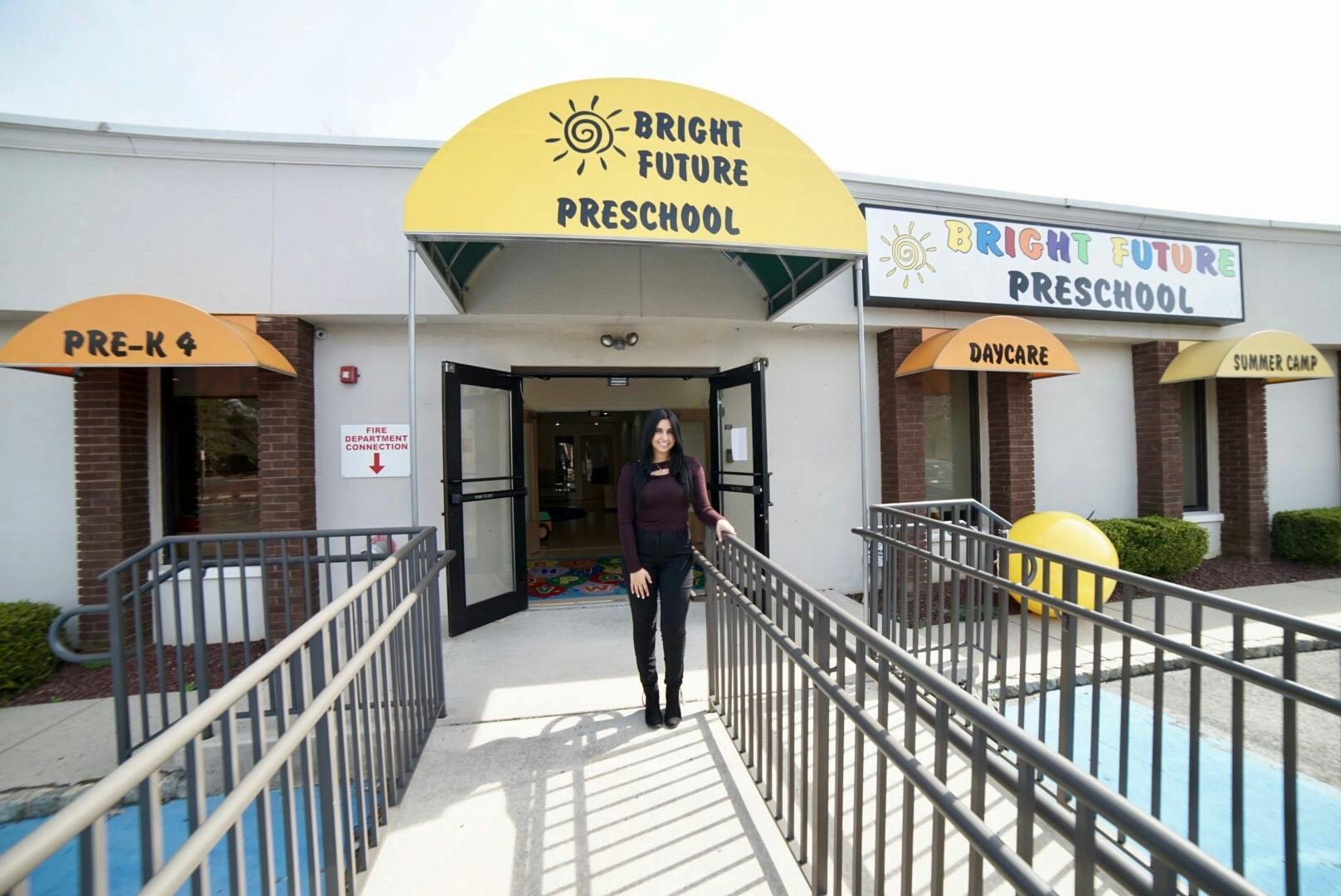 Person standing at the entrance of Bright Future Preschool