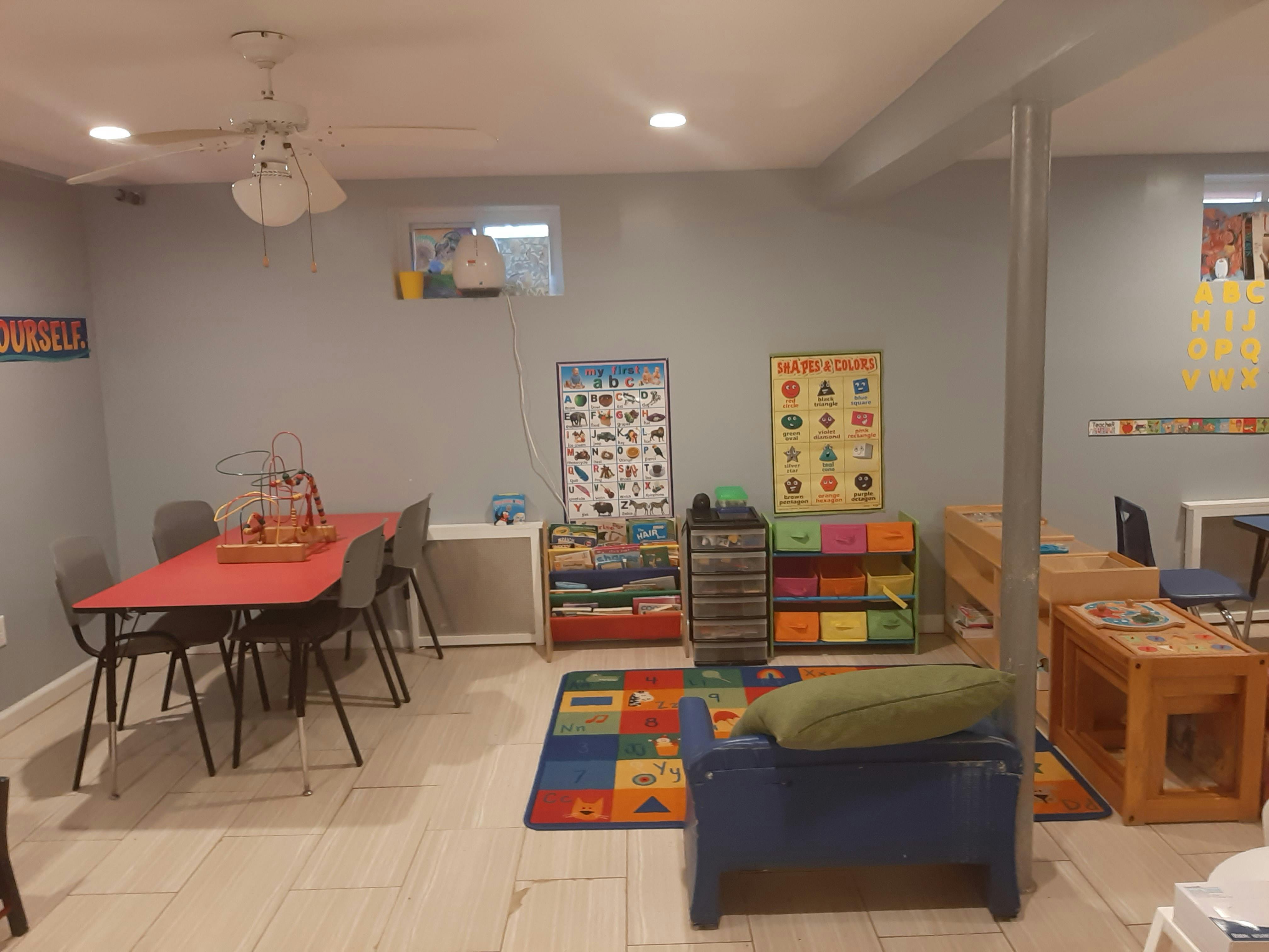Classroom with tables, chairs, and colorful learning materials