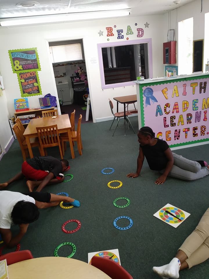 Children playing on the floor with colorful rings in a learning center