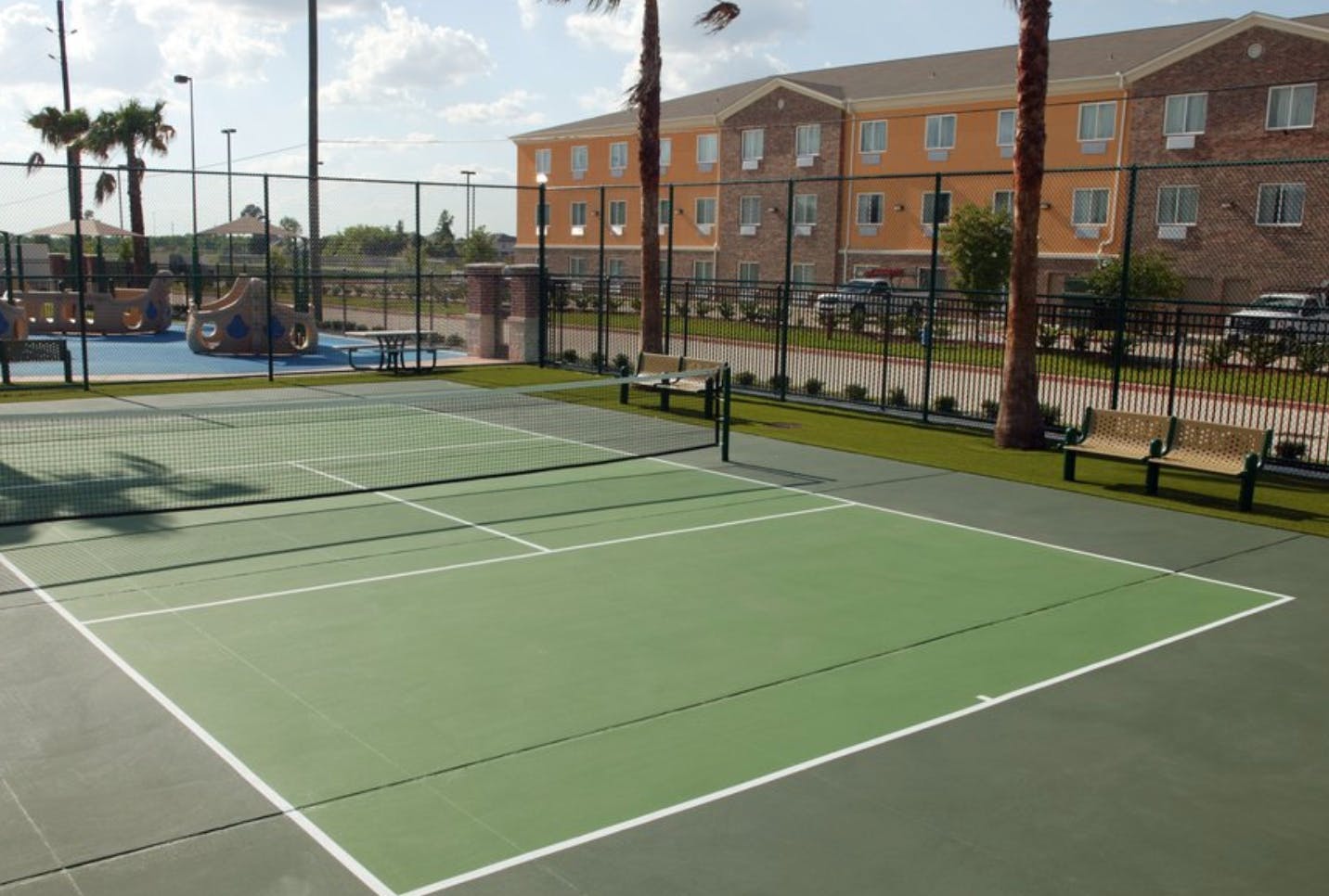 Outdoor tennis court with a net and white lines
