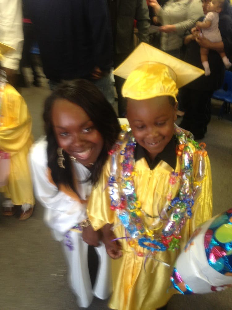 Person and child in graduation gowns