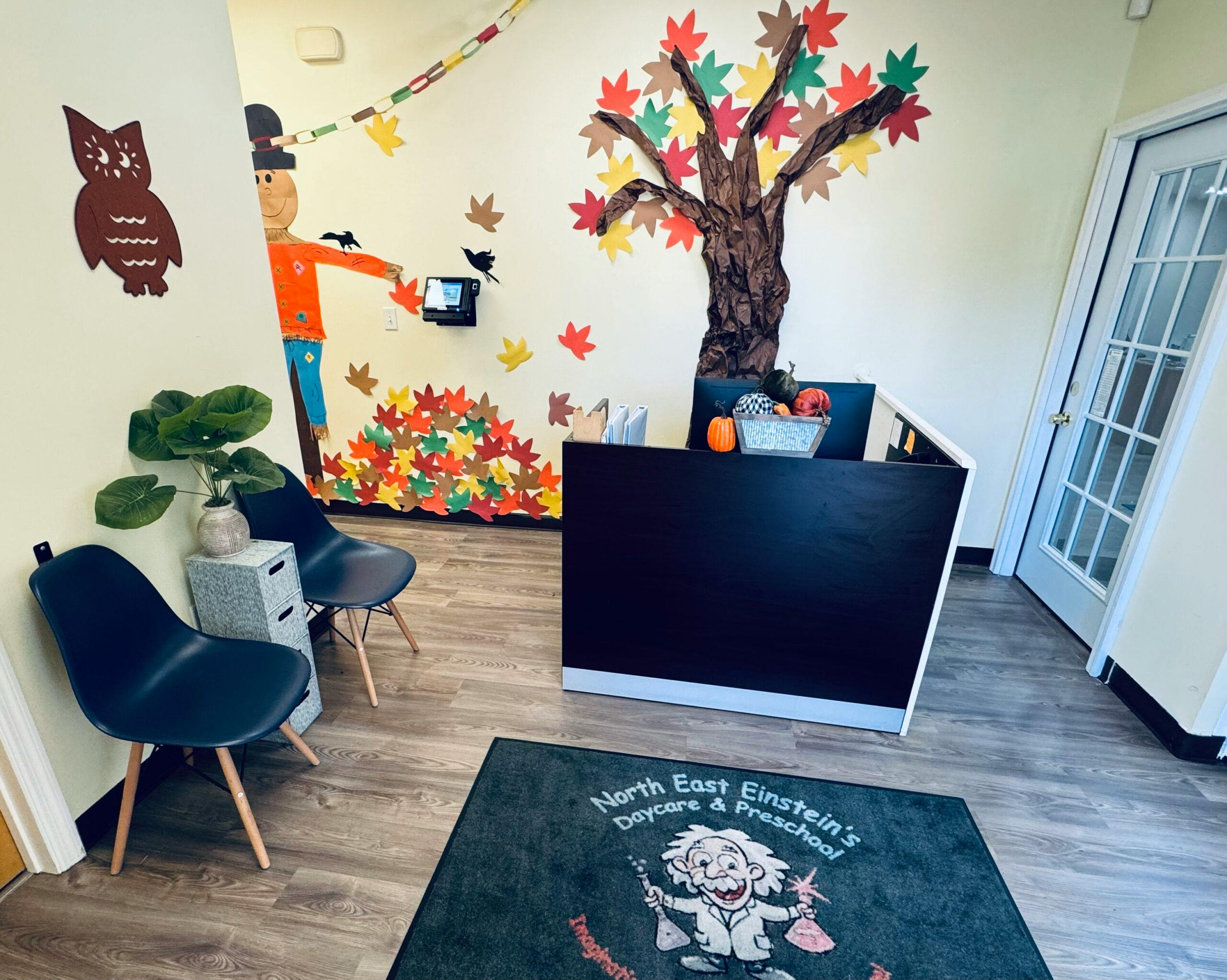 Reception area with fall-themed wall decorations and a welcome mat