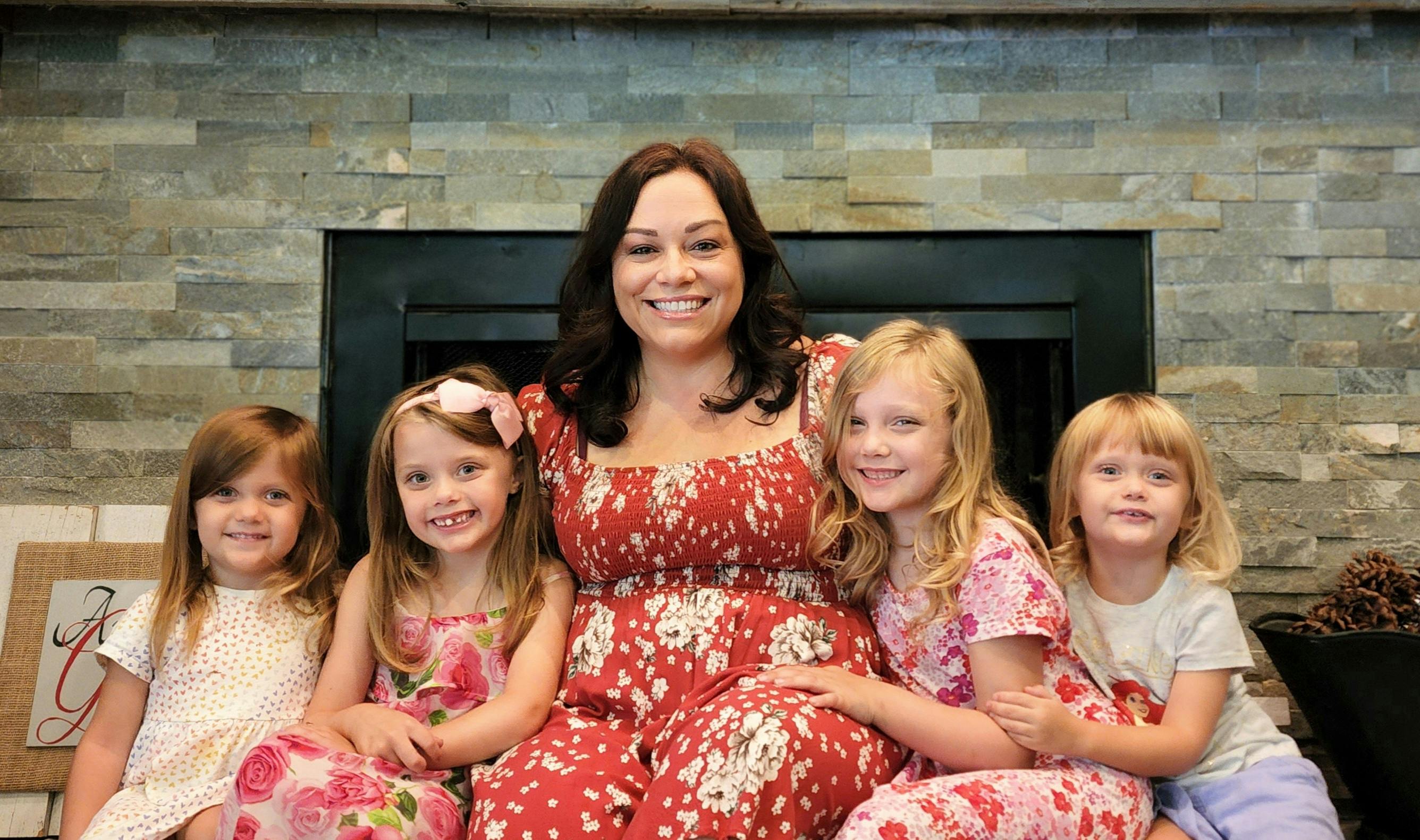 Person sitting with four children