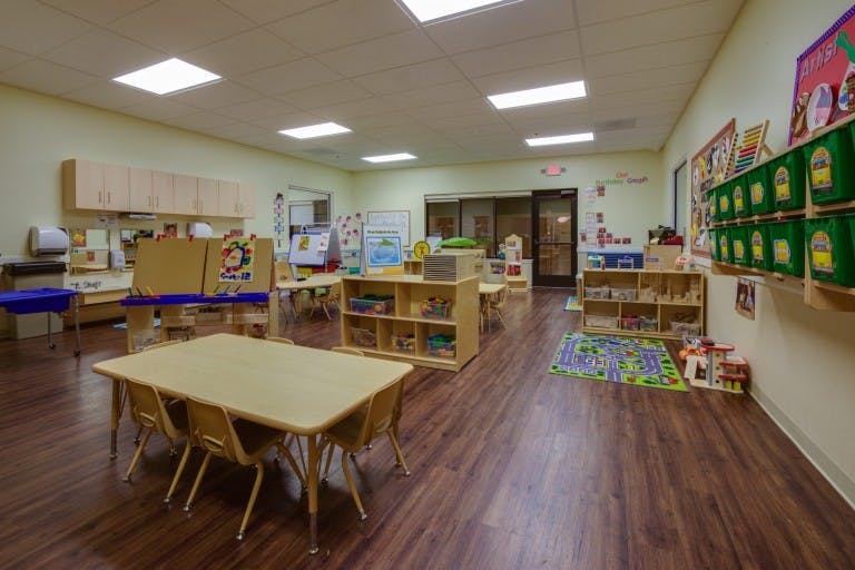 Empty classroom with small tables and chairs