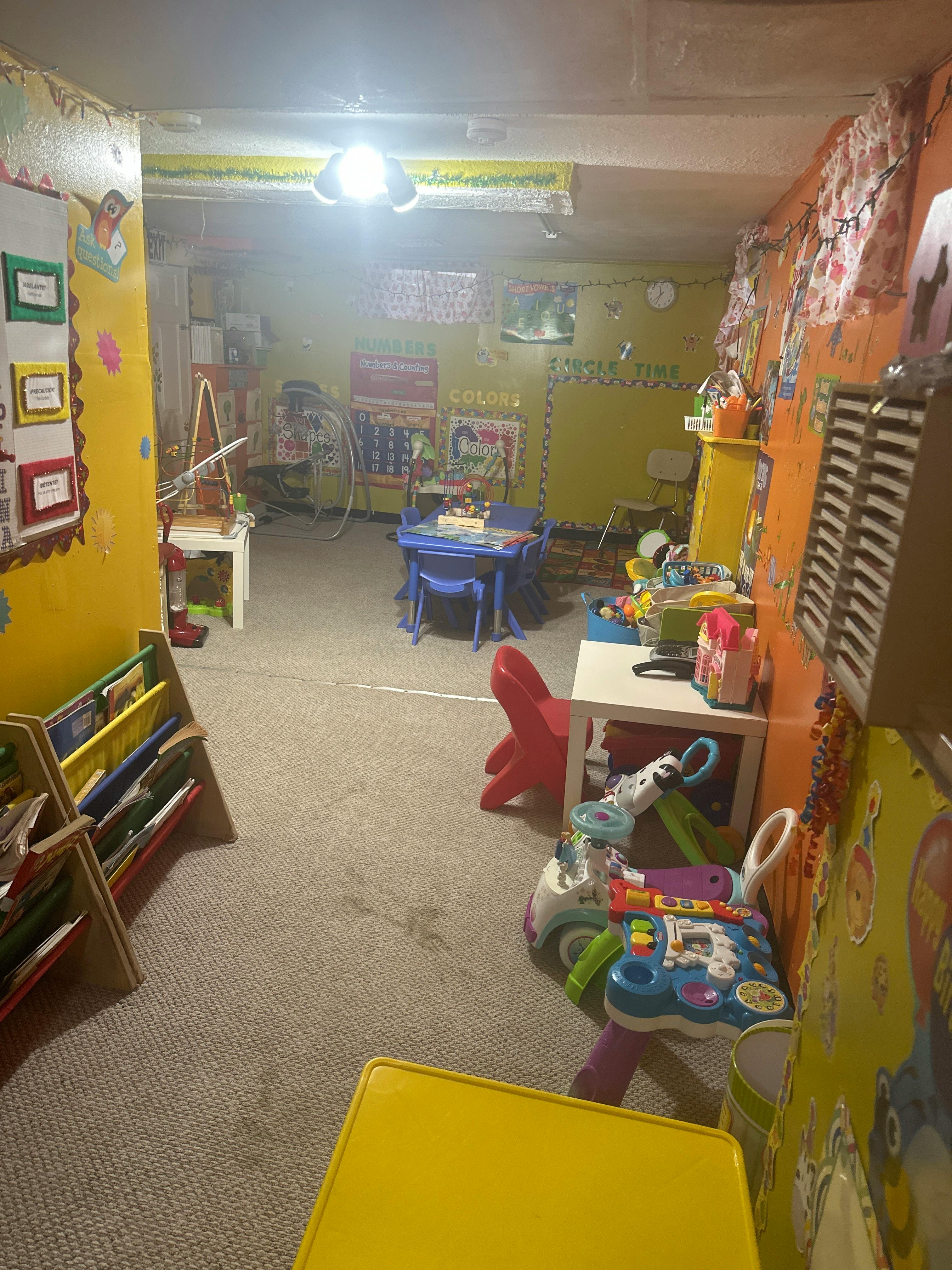 Playroom with small tables, chairs, and toys