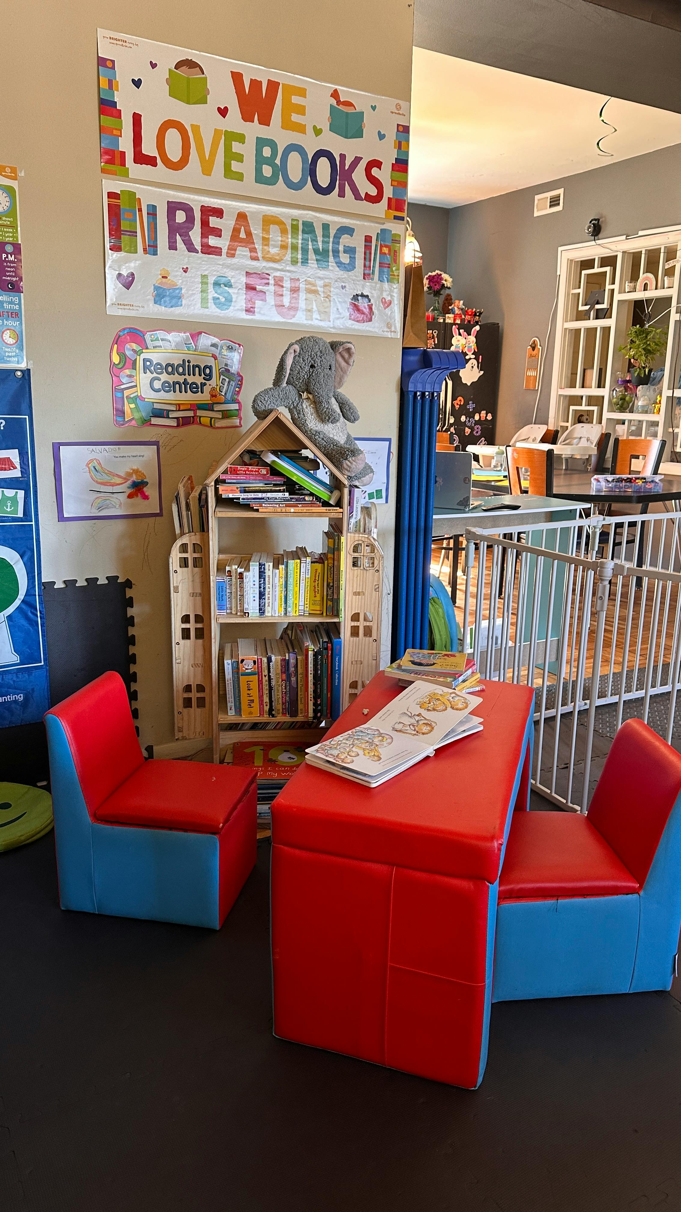 Children's reading area with a bookshelf, small table, and chairs