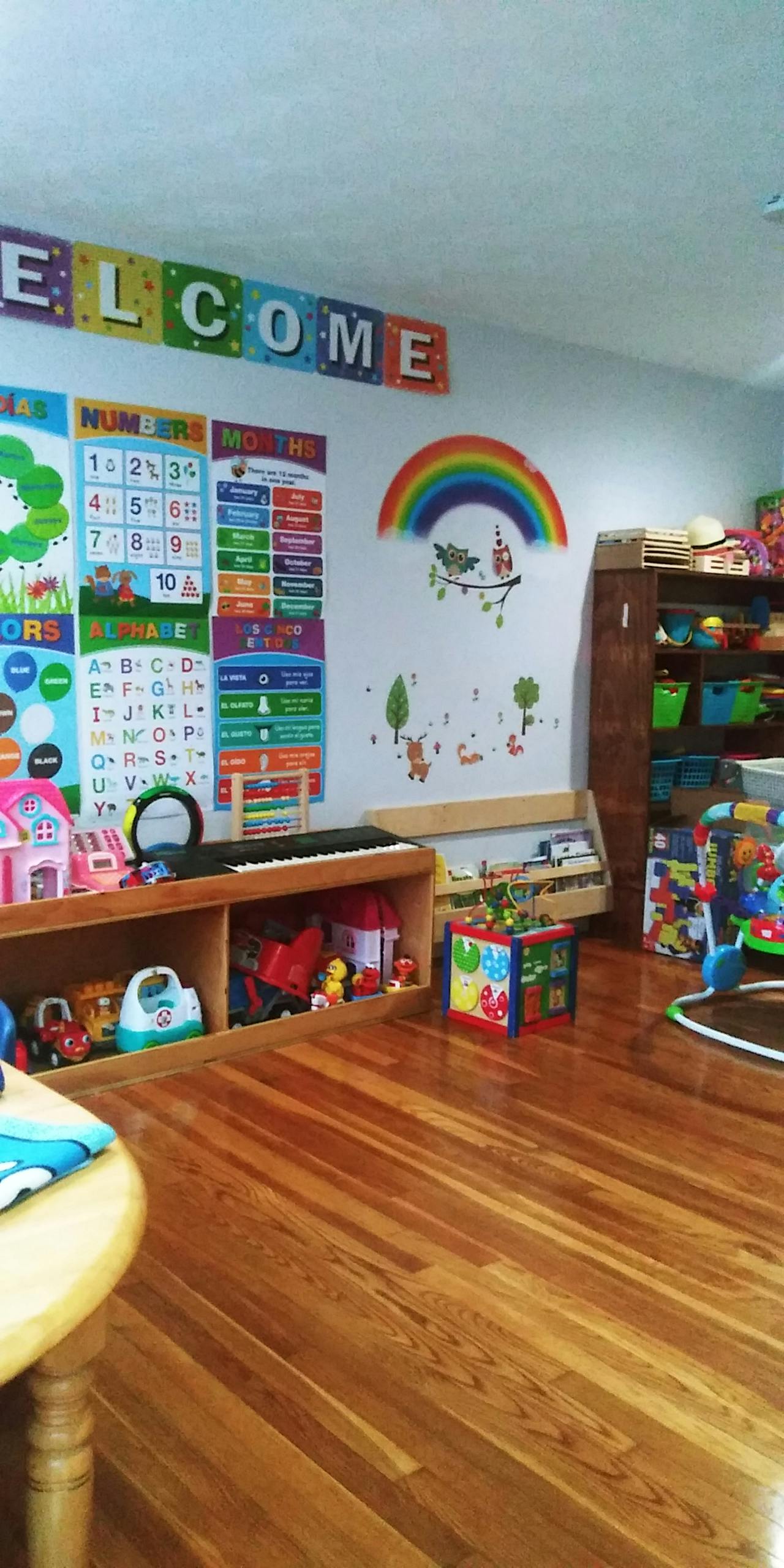 Classroom with educational posters, toys, and a "WELCOME" sign