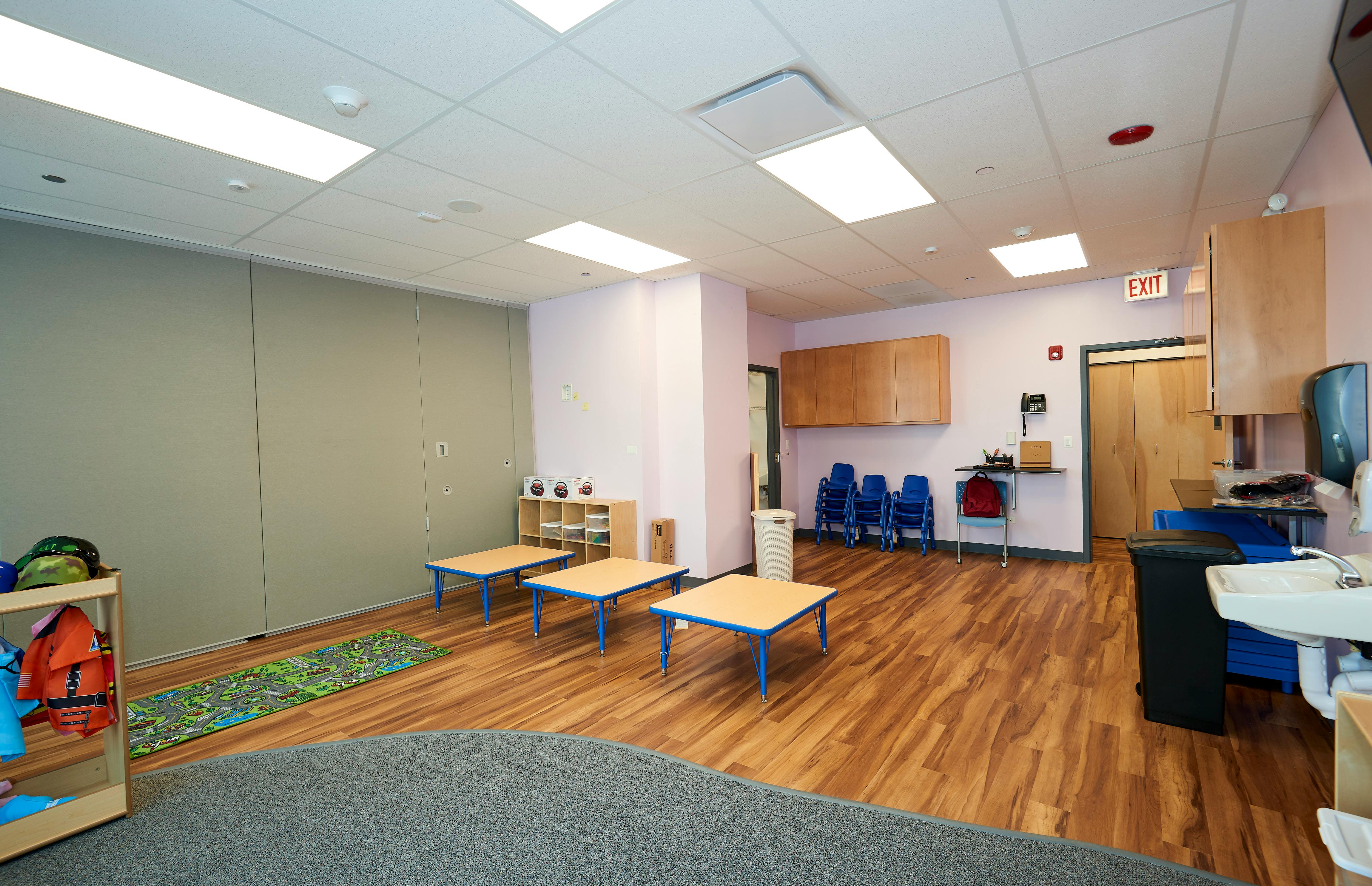 Empty classroom with small tables and chairs