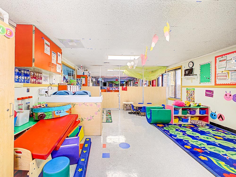 Children's classroom with colorful play mats and activity areas