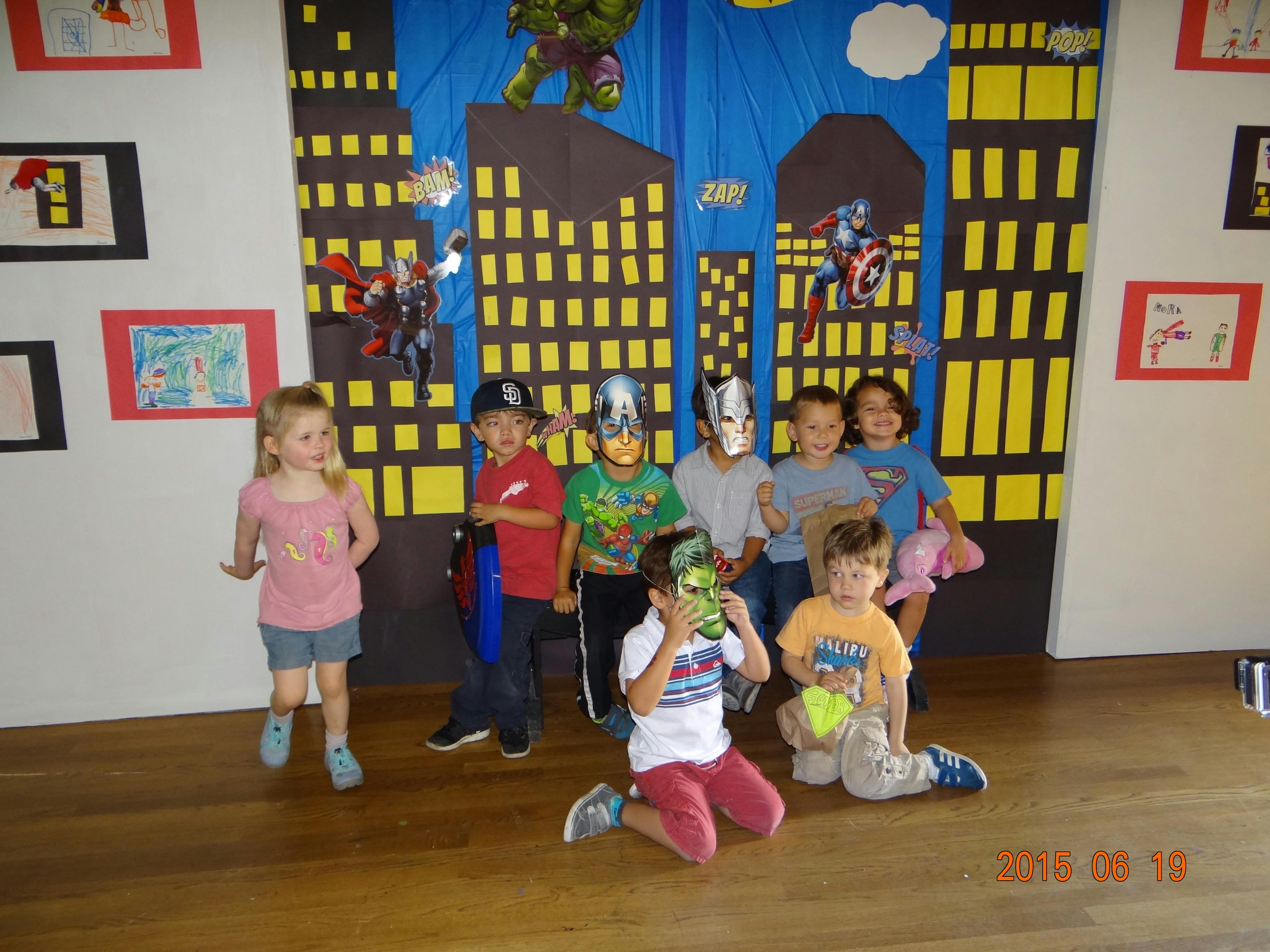 Group of children in front of a superhero cityscape backdrop