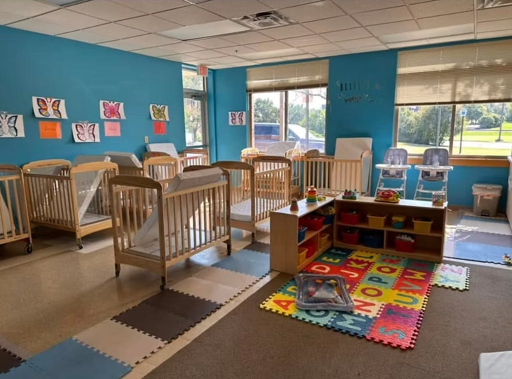 Cribs and play area in a daycare room