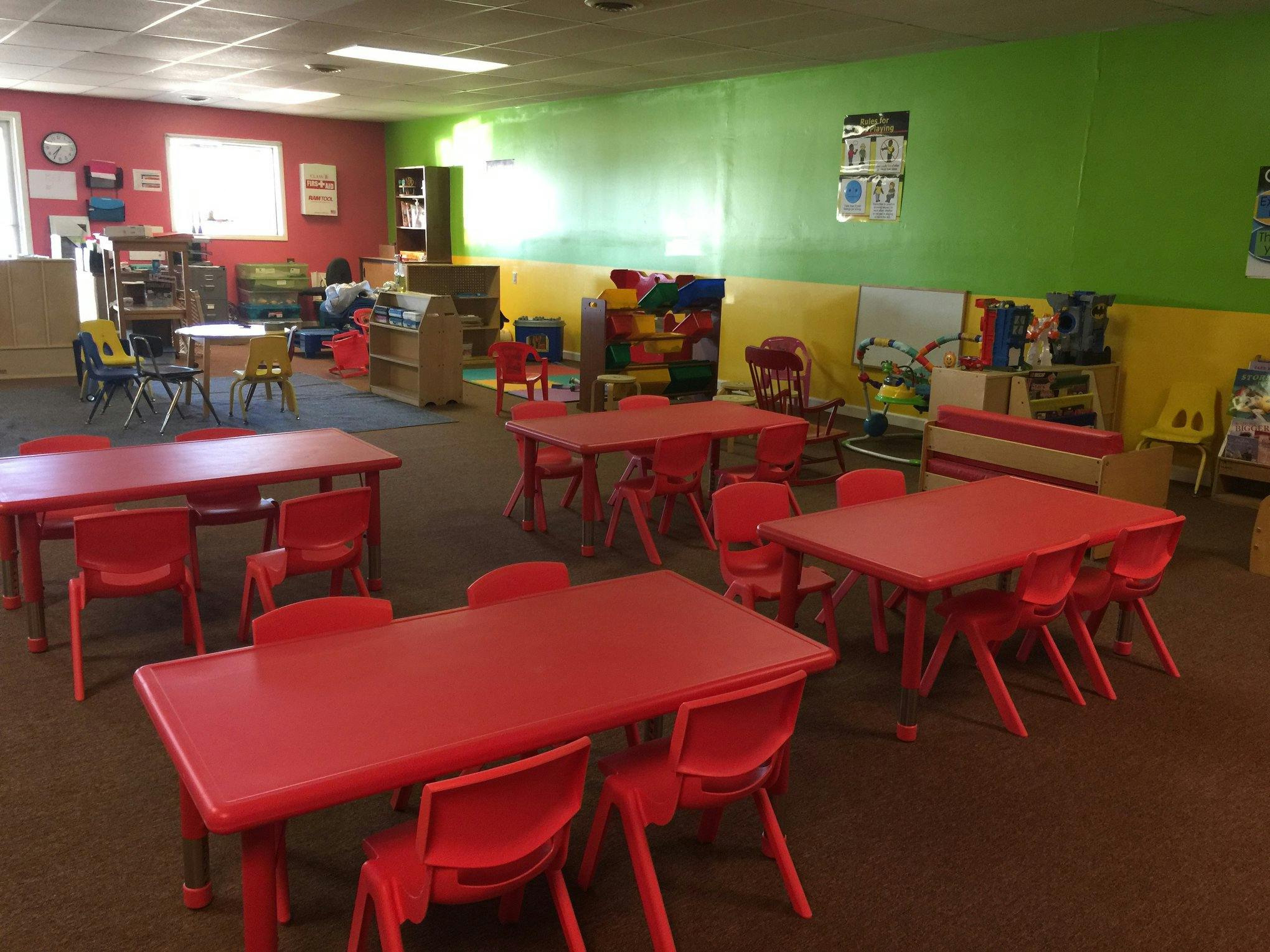Classroom with red tables and chairs
