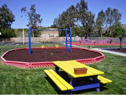 Picnic table and swing set on a playground