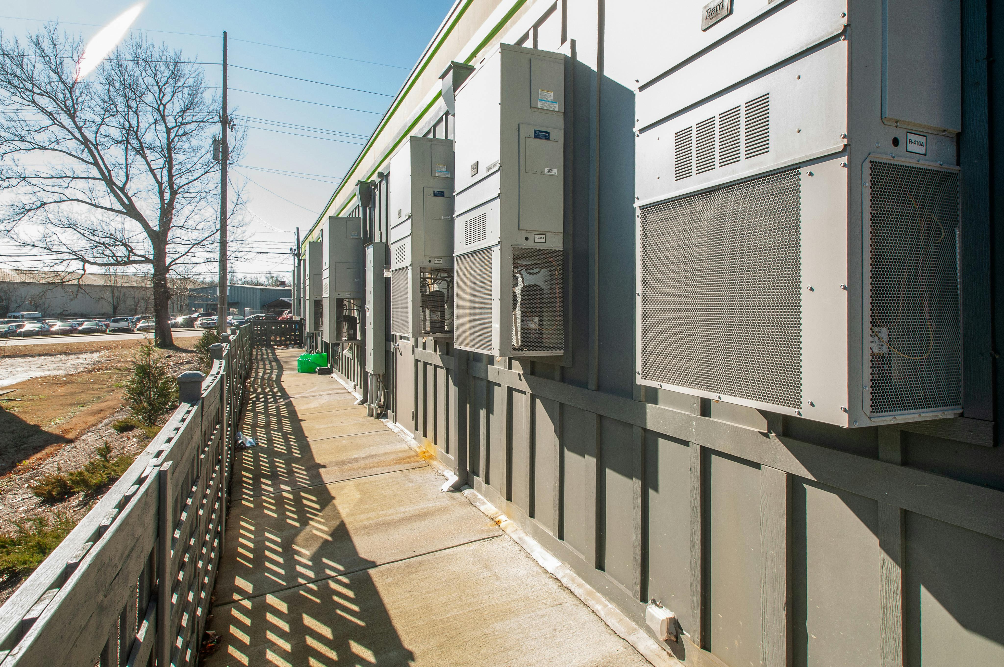 Row of air conditioning units mounted on a building exterior