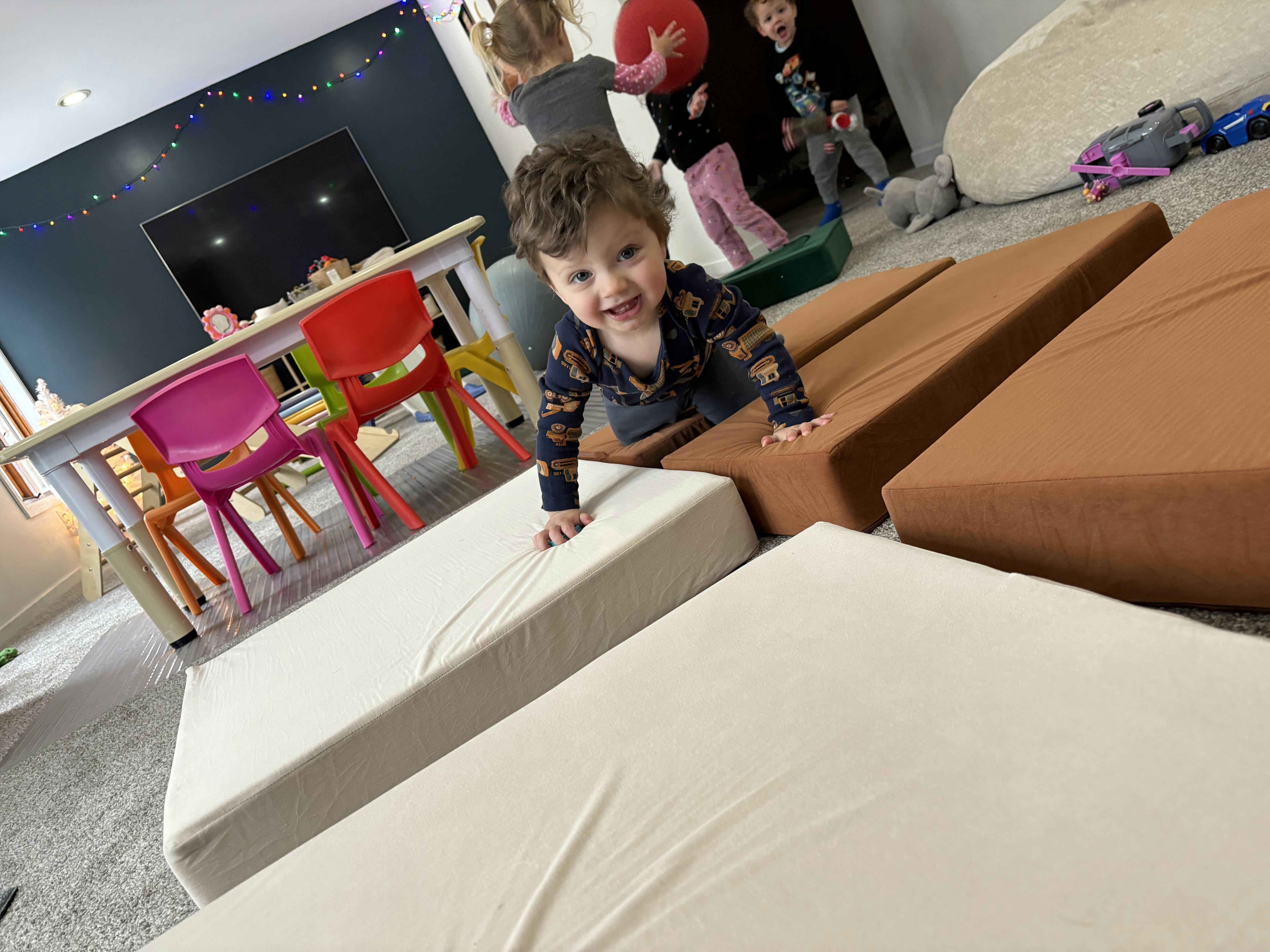 Child crawling on soft play mats