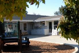 Building exterior with a paved courtyard and trees