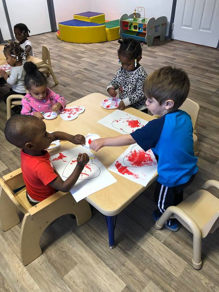 Children painting at a table