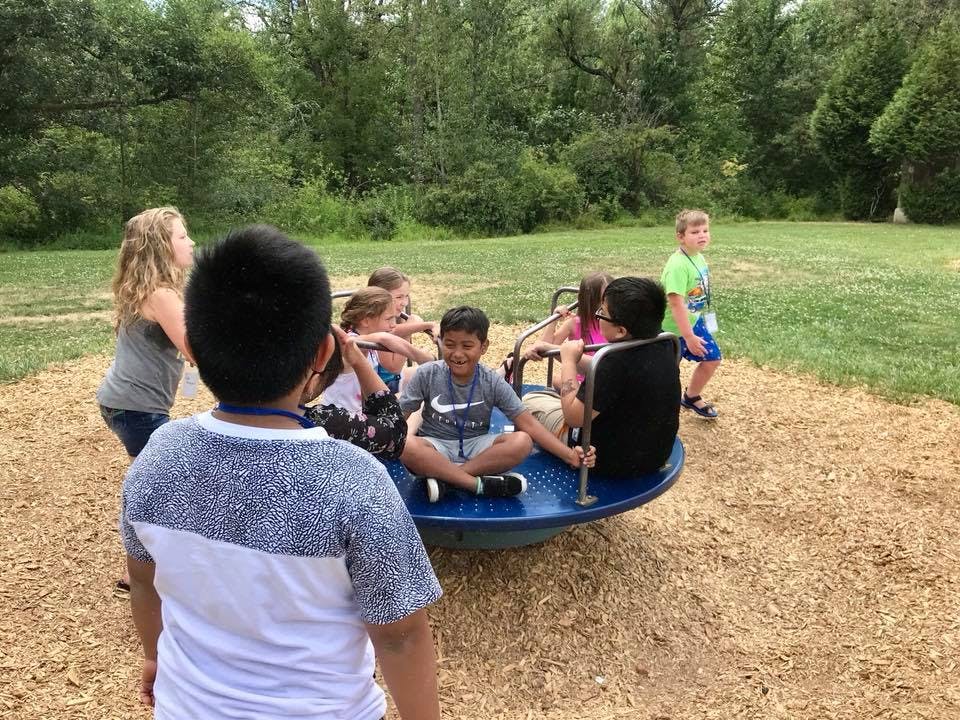 Children playing on a merry-go-round at a playground