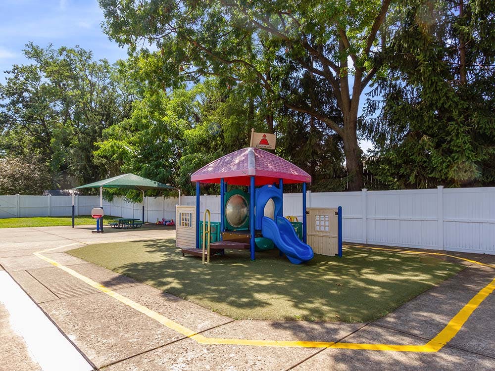 Playground with a play structure featuring a slide and a shaded picnic area
