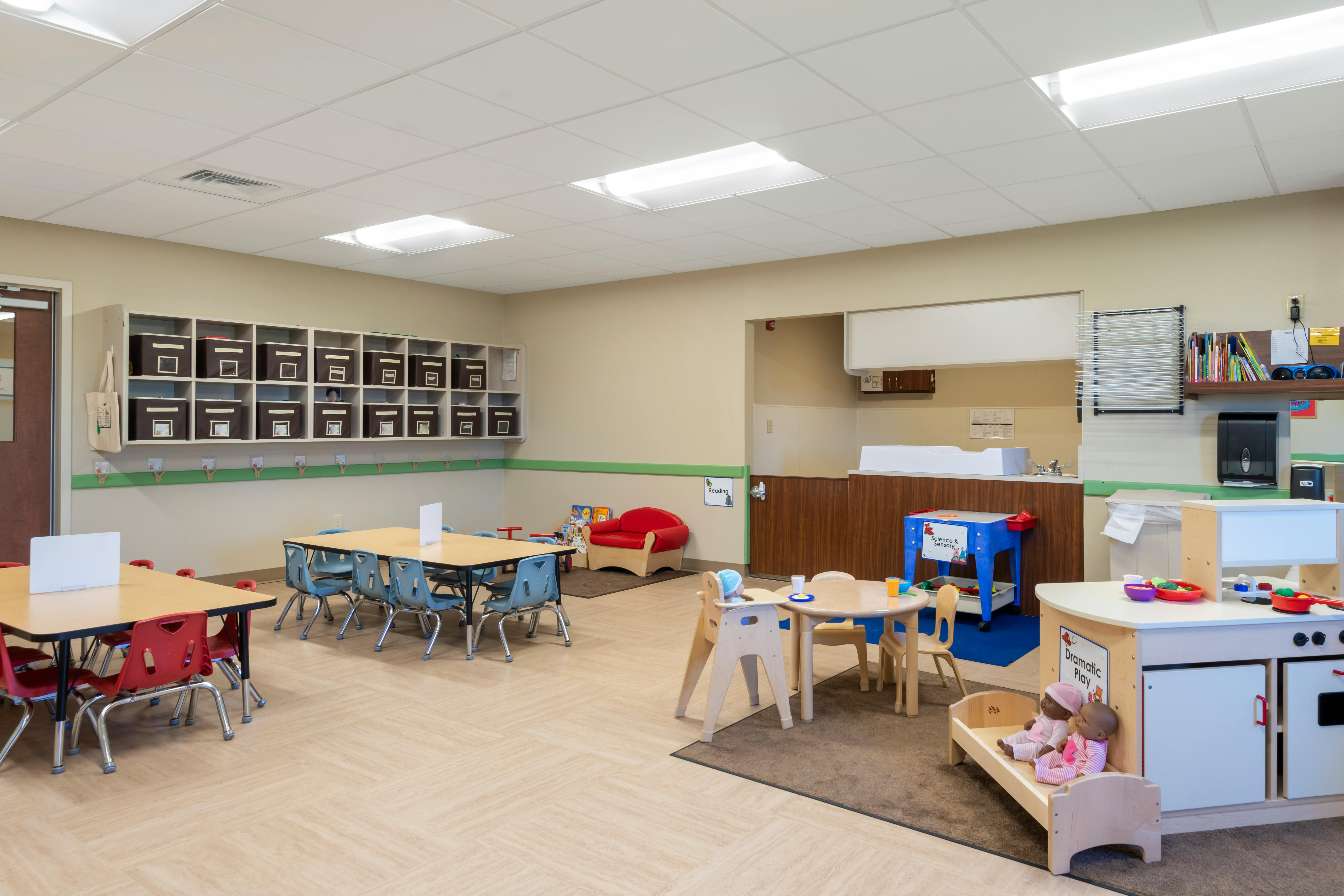 An empty early childhood classroom with multiple activity areas