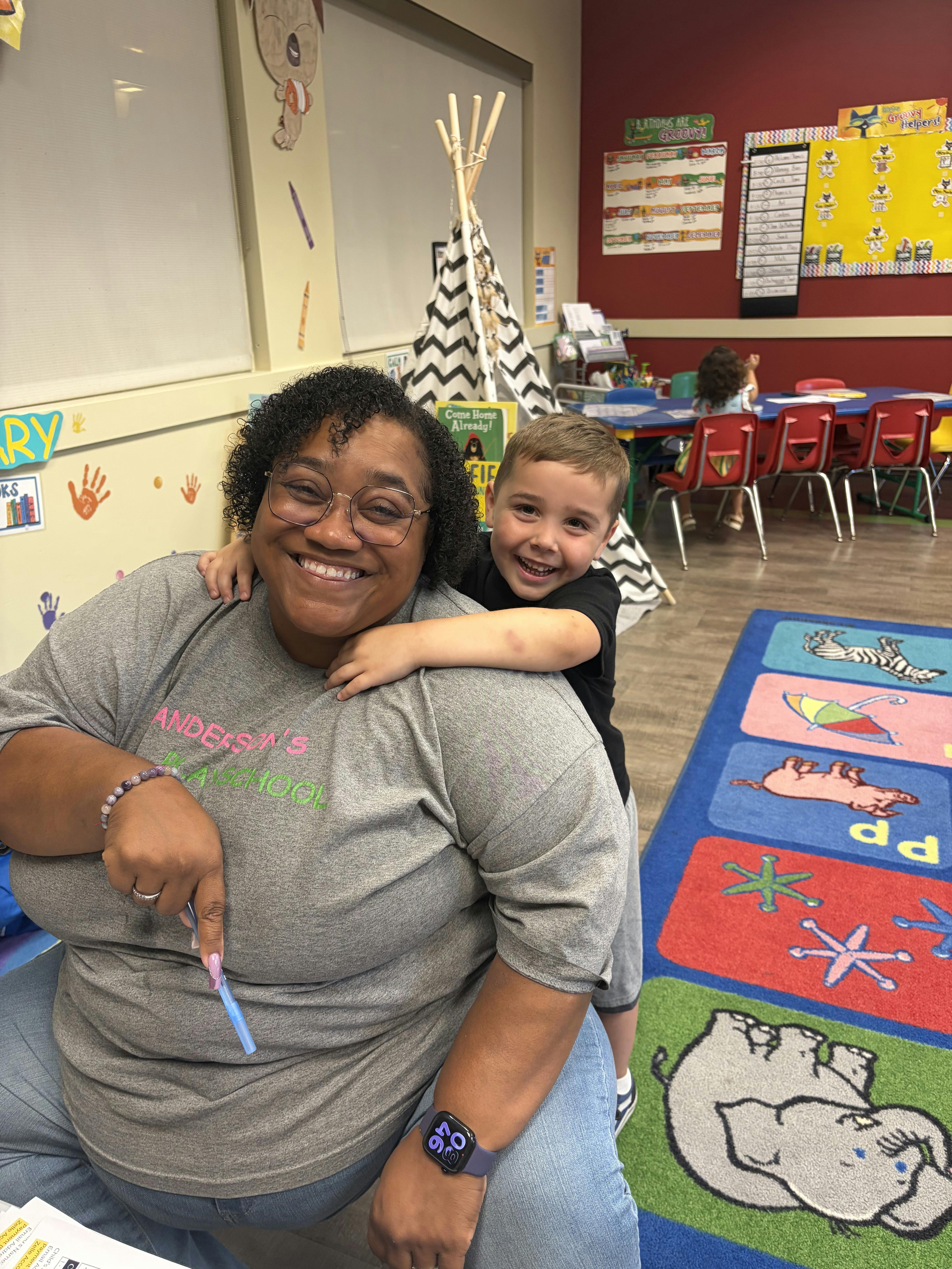 A person and a child in a classroom