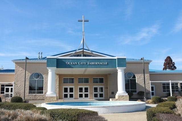 Ocean City Tabernacle building with a cross on top and a fountain in front