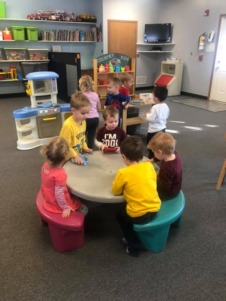 Children sitting around a table in a classroom