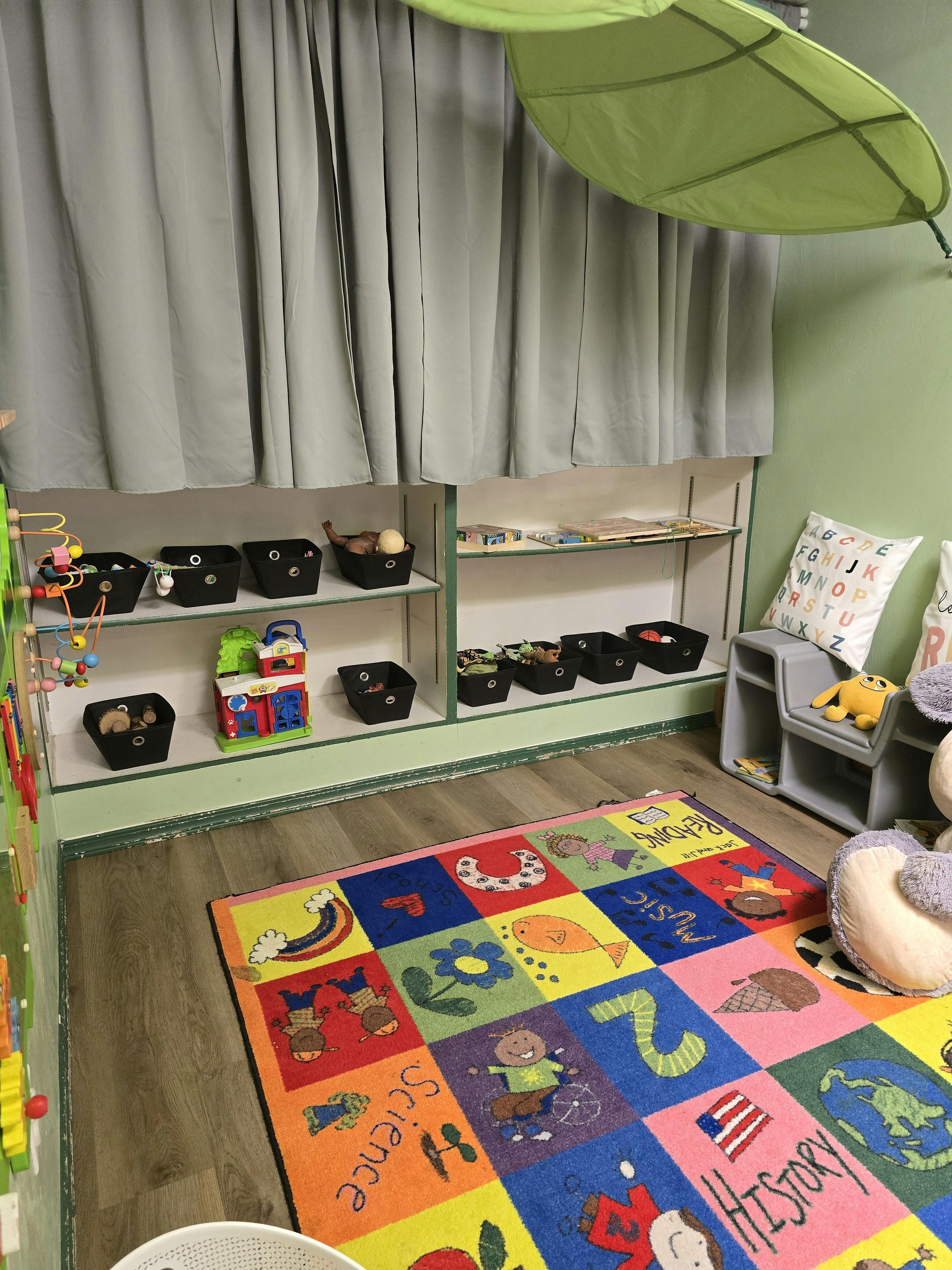 Colorful educational area for children with toy storage shelves and a play rug